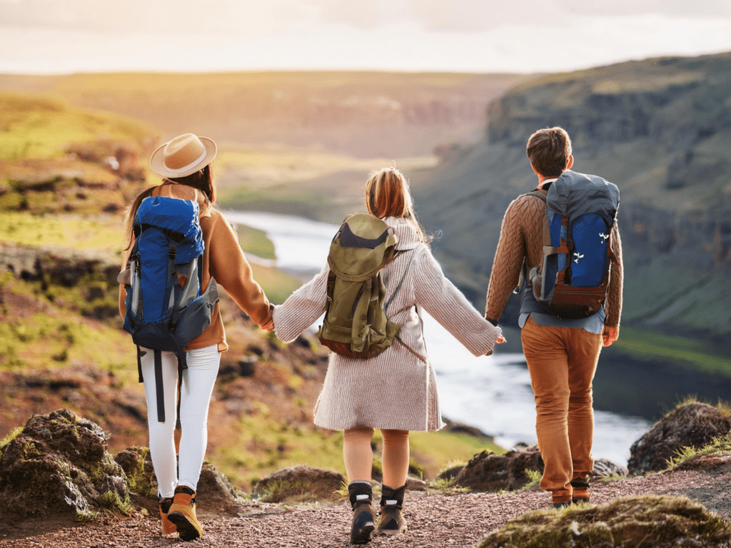 Friends holding hands while travelling