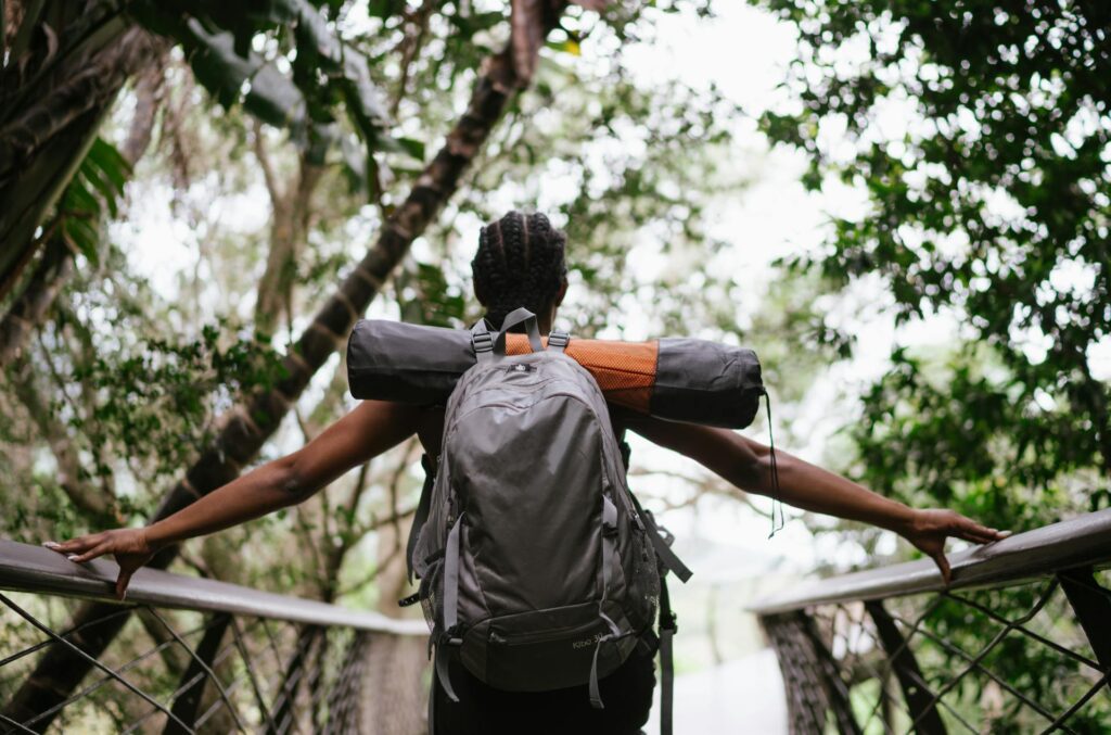 Photo Of Woman Standing On Foot Bridge