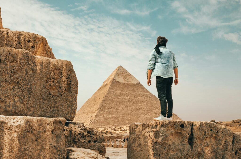 Traveler standing on stone monument in desert